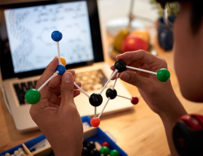 Image of a male student studying science